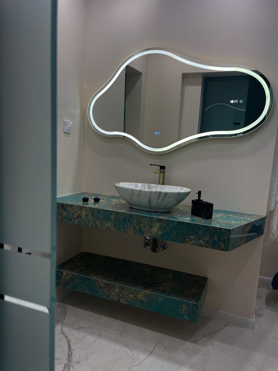 Irregular cloud-shaped LED mirror with backlit halo glow