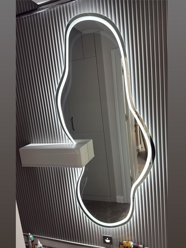 Melt Silhouette — irregular organic-shaped LED mirror with halo glow, made to order by Lume